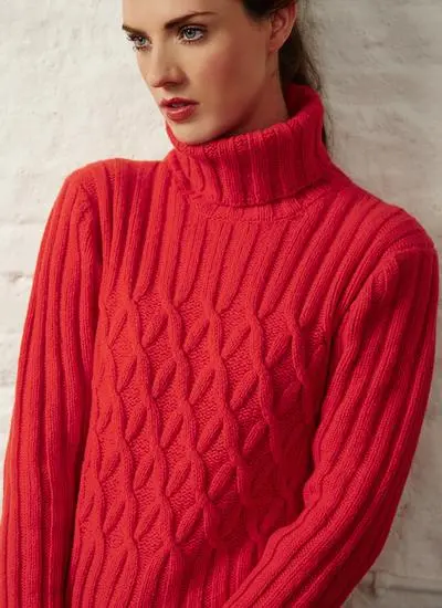 studio shot of brunette woman wearing a bright red polo neck sweater 